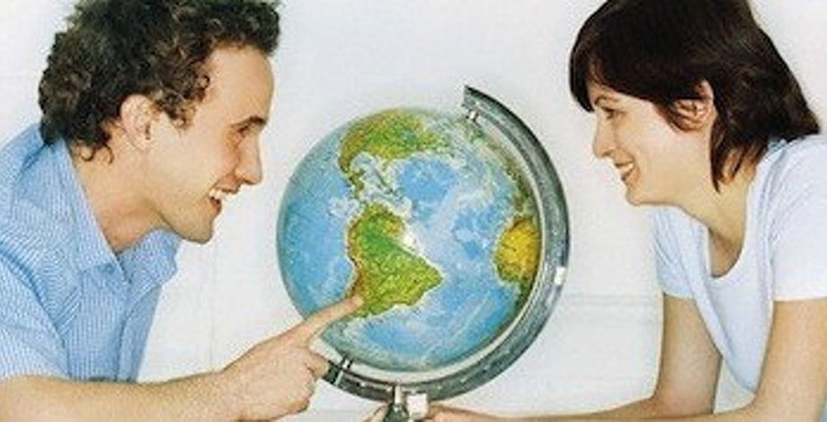 Young couple with globe --- Image by © S. Hammid/zefa/Corbis