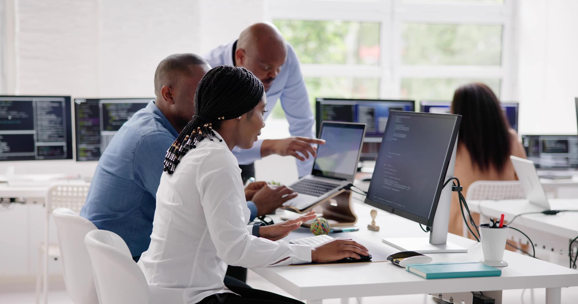 African Business Team Working On Computer. Software App Development