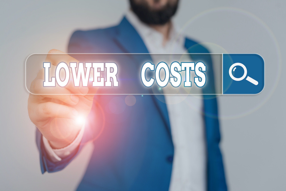 Writing note showing Lower Costs. Business concept for the business sets low price to enhance theproduct deanalysisd