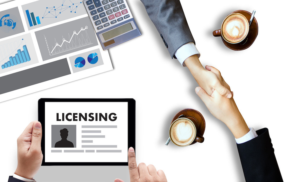 Patent License agreement LICENSING   business man hand working on laptop computer